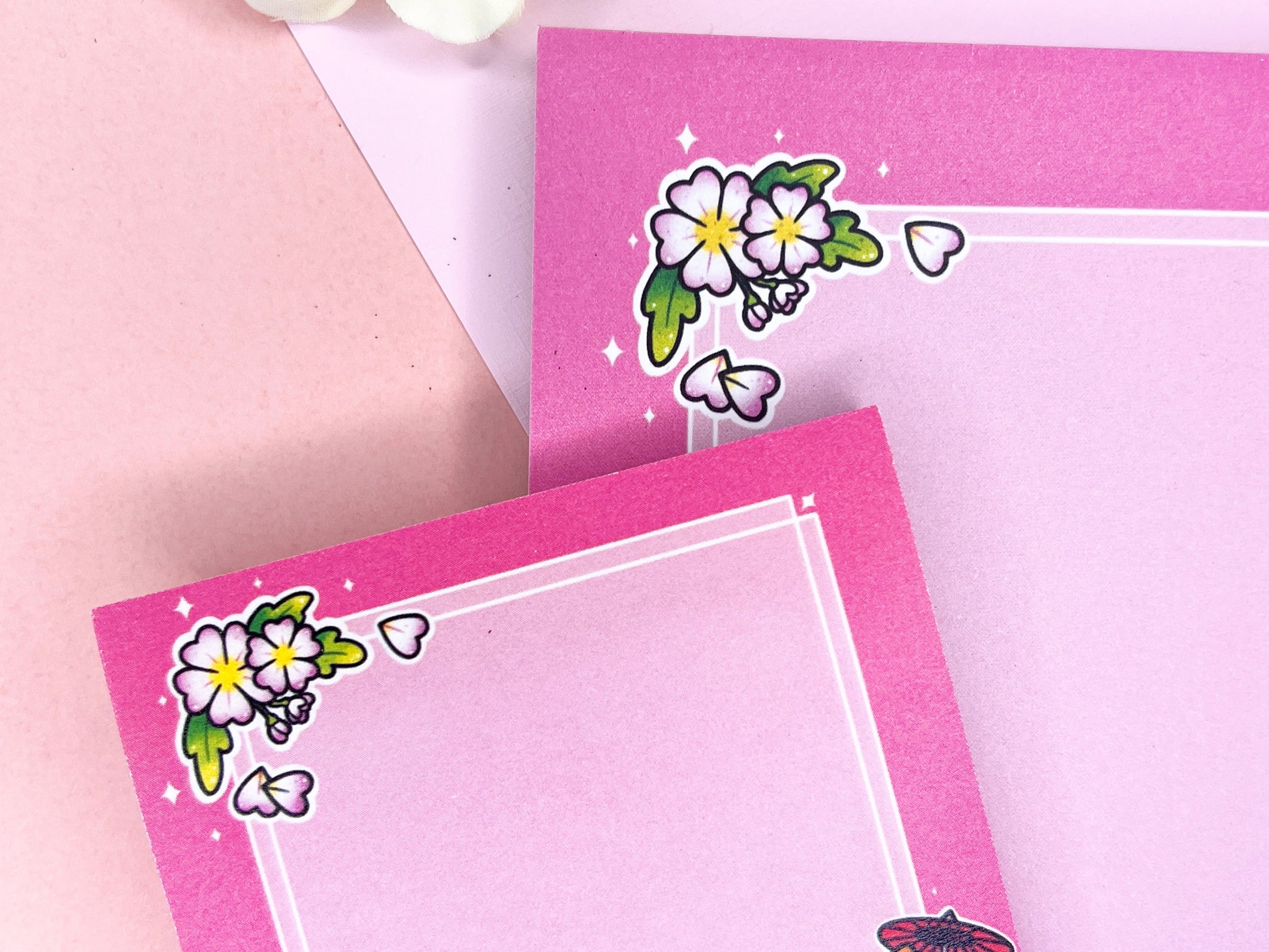 A pink gift set, including sticky notes and a notepad, that has an illustration of a cute dog wearing a pink kimono holding an umbrella under cherry blossoms. 