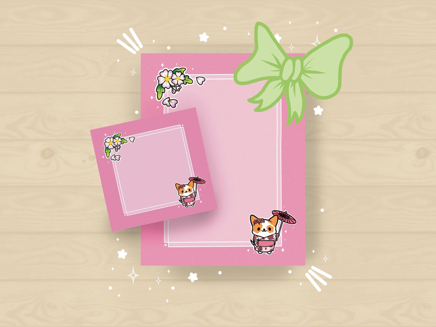 A pink gift set, including sticky notes and a notepad, that has an illustration of a cute dog wearing a pink kimono holding an umbrella under cherry blossoms. 