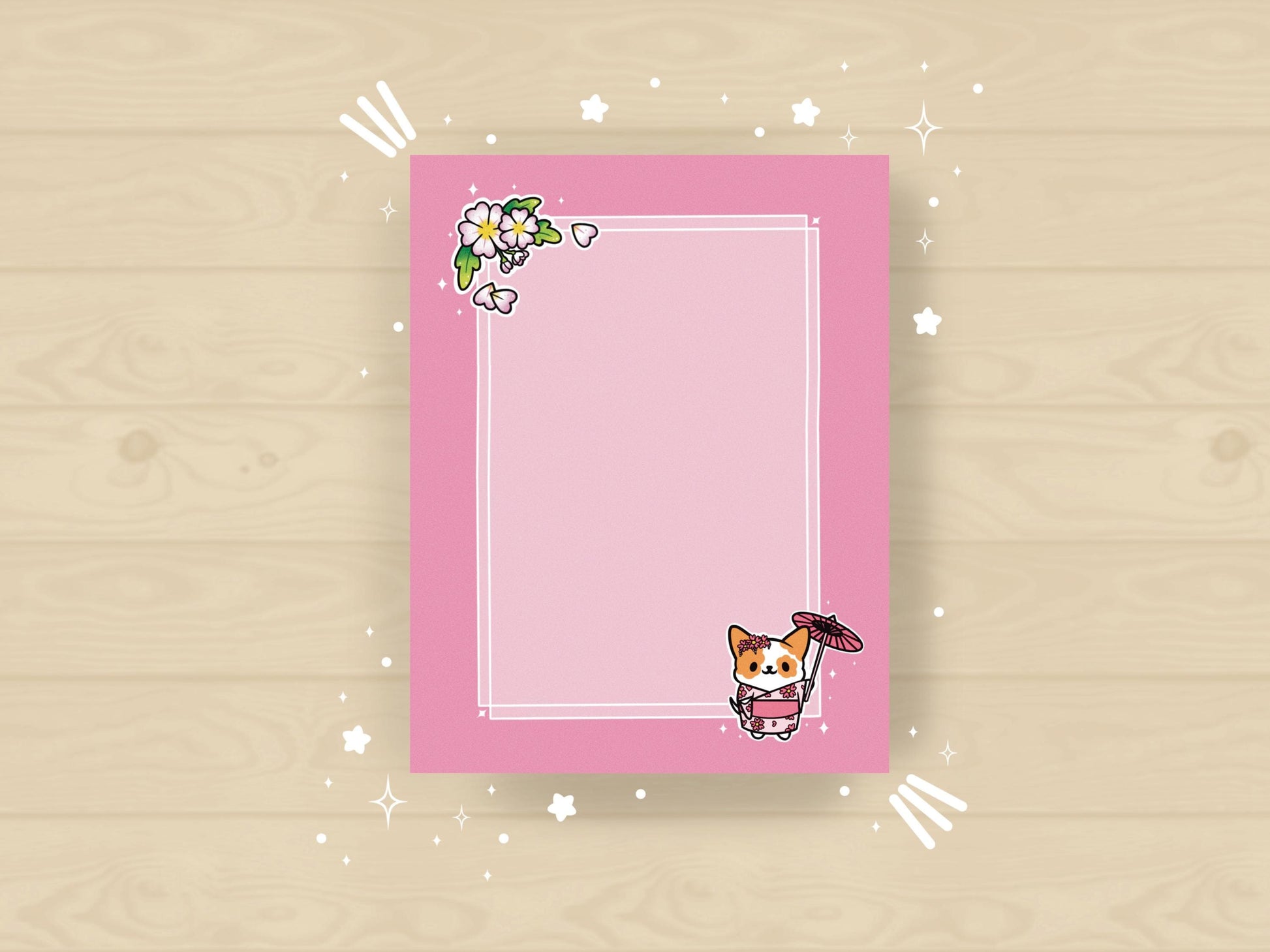 A pink notepad that has an illustration of a cute dog wearing a pink kimono holding an umbrella under cherry blossoms. 