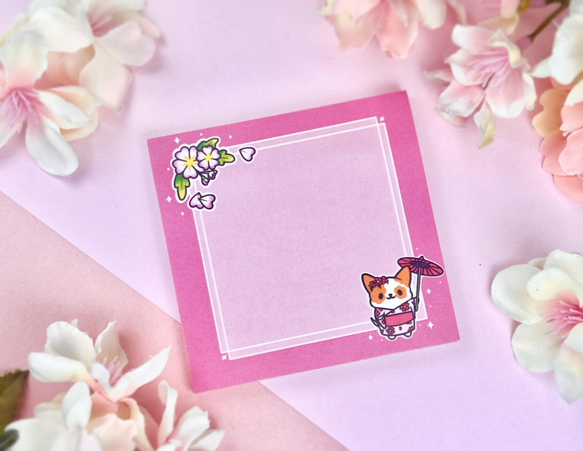 Pink sticky notes that have an illustration of a cute dog wearing a pink kimono holding an umbrella under cherry blossoms. 