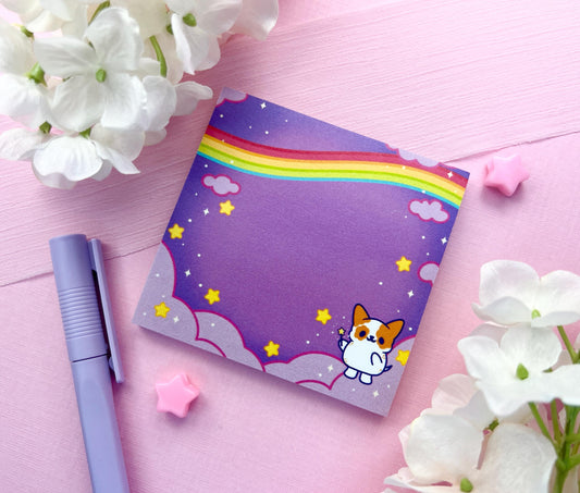 Purple sticky notes of a cute magical dog standing the the clouds below a rainbow surrounded by yellow stars holding a magical wand.
