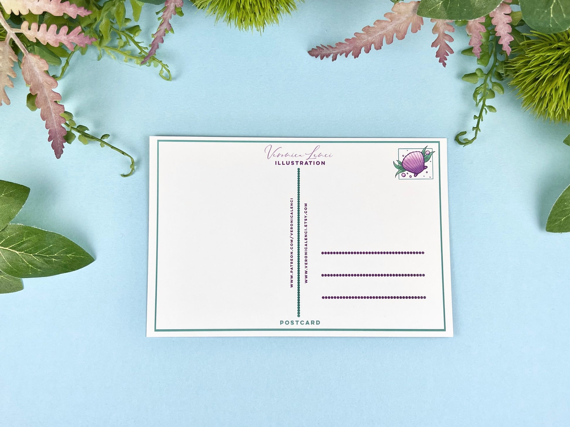 Back of the postcard with a line down the middle, lines on the right side for and address, and a cute shell illustration where the stamp would go. 