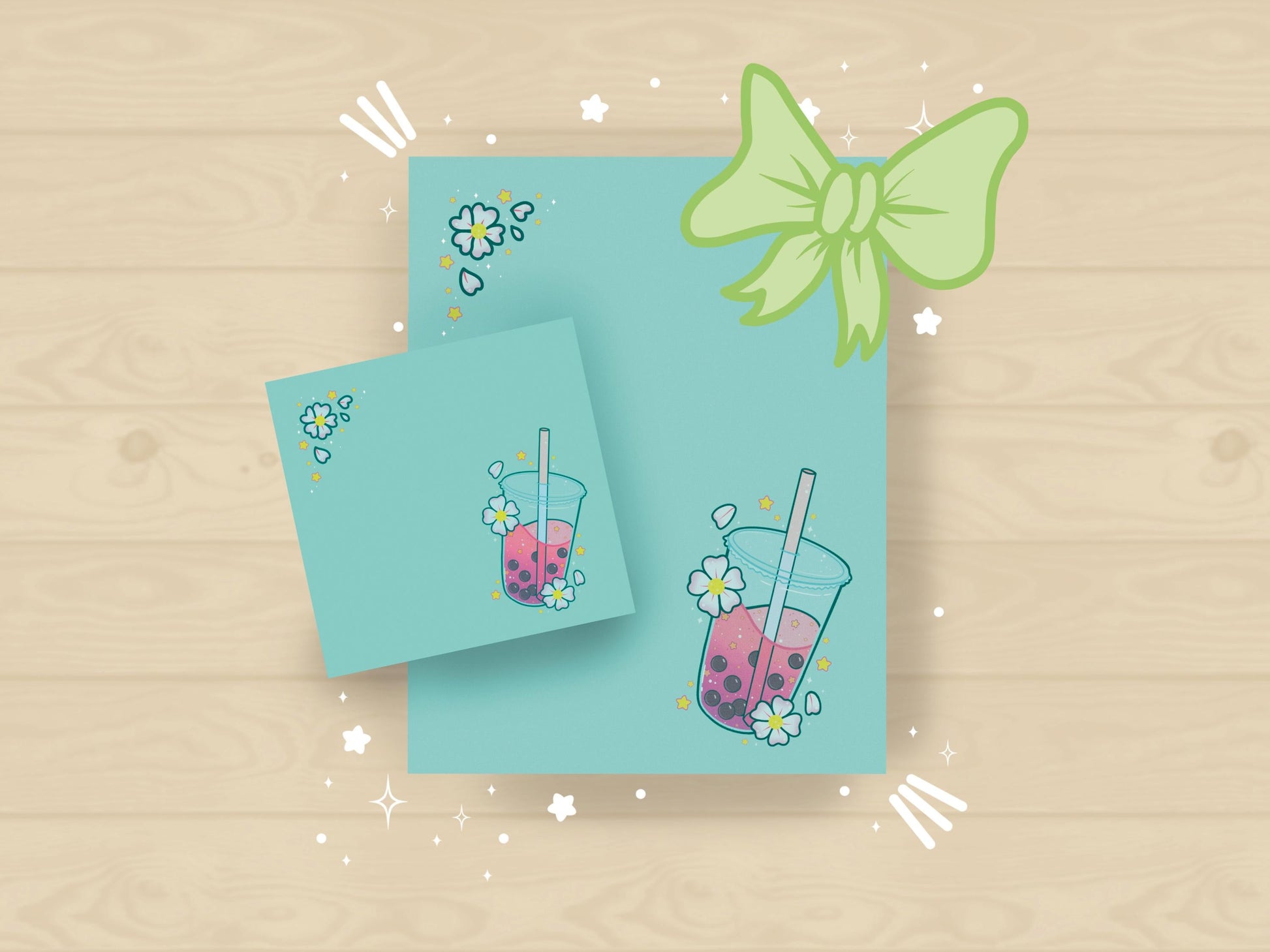 A light blue gift set including one sticky note and one notepad with an illustration of pink boba milk tea surrounded by pink flowers and yellow stars.