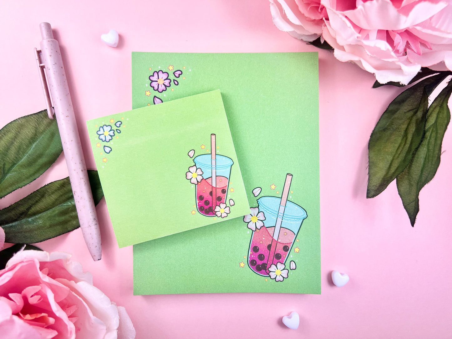 A green gift set including one sticky note and one notepad with an illustration of pink boba milk tea surrounded by pink flowers.