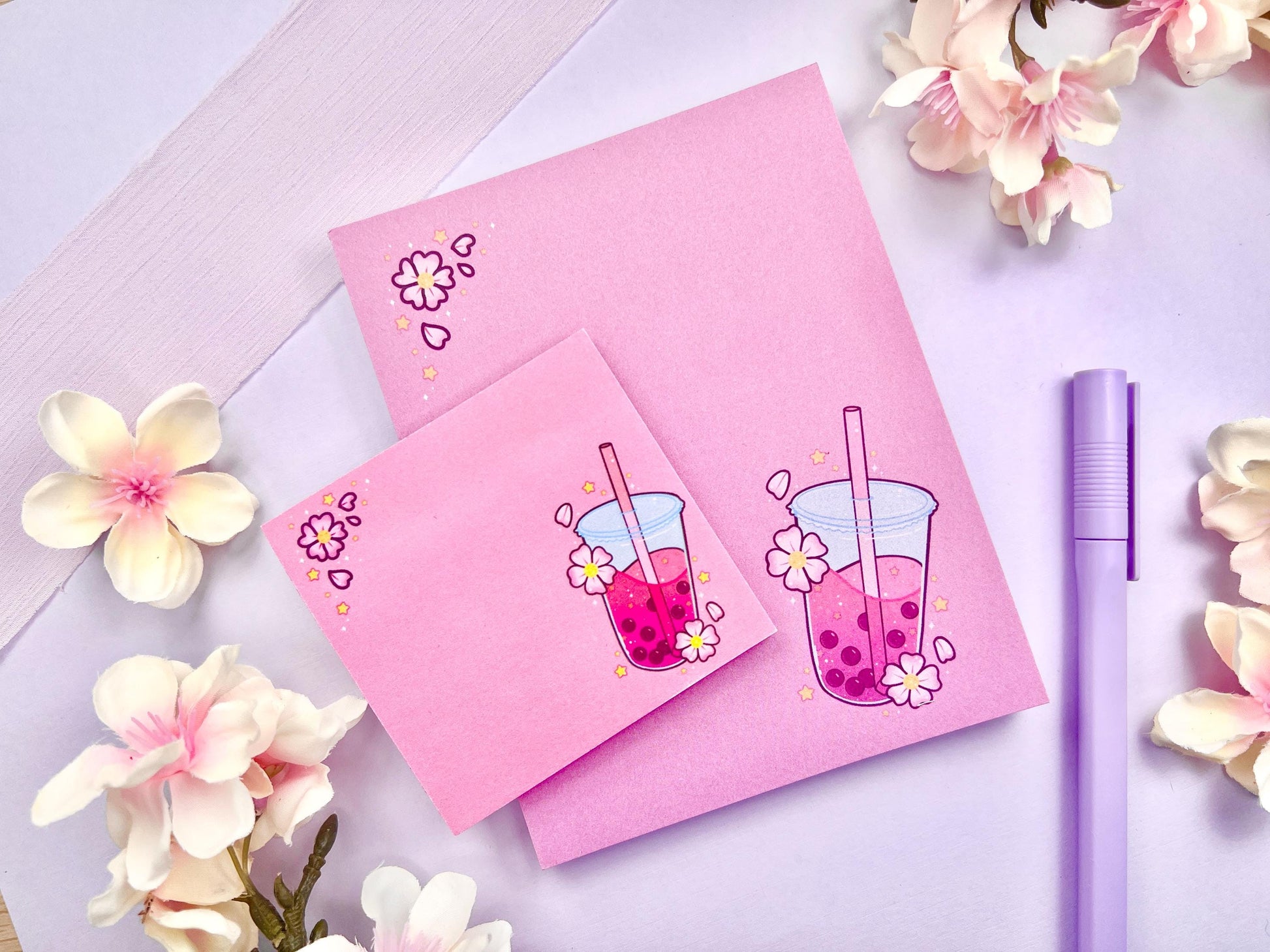 A pink gift set including one sticky note and one notepad with an illustration of pink boba milk tea surrounded by pink flowers.
