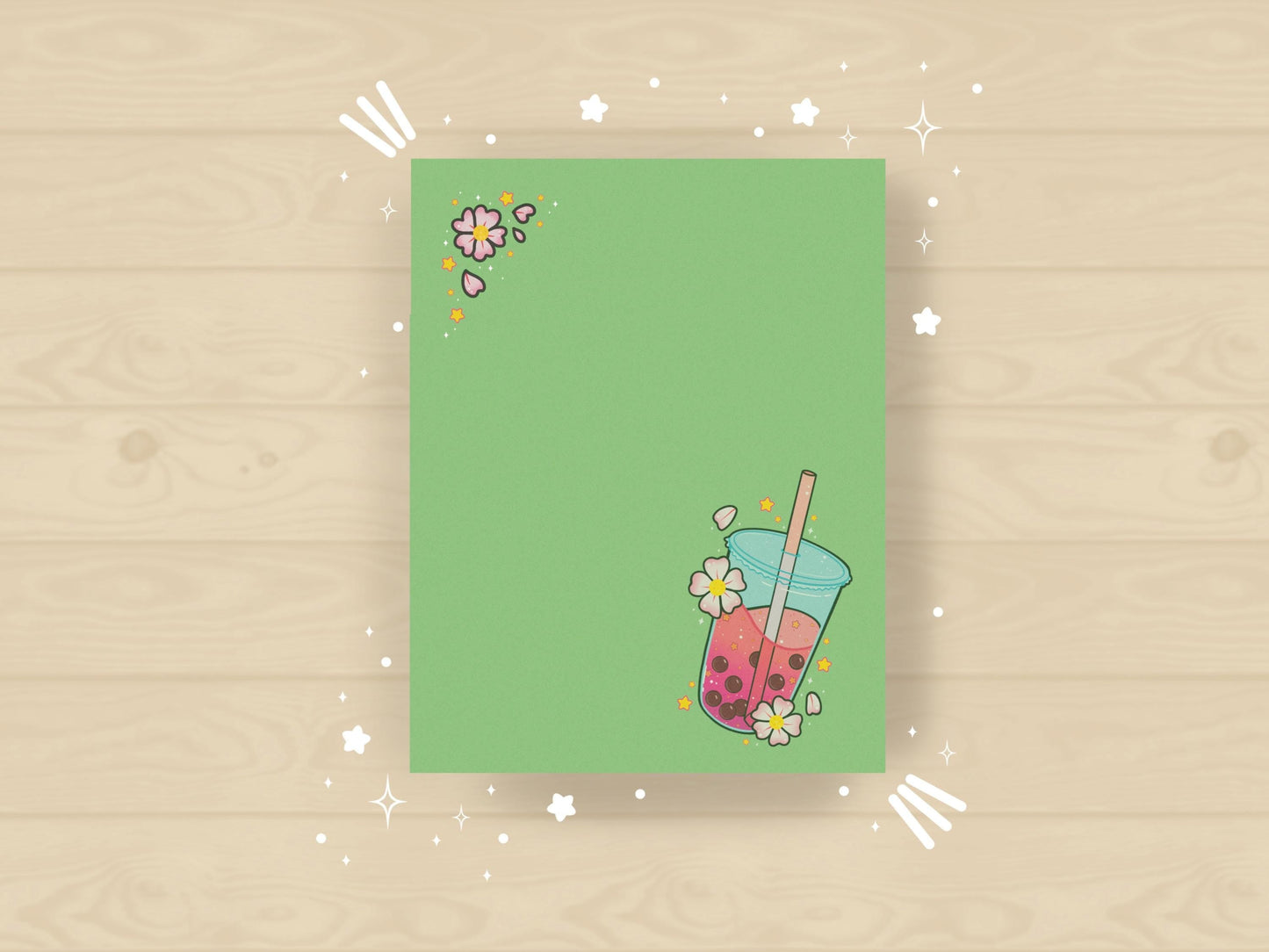 Green notepad with a pink boba milk tea illustration surrounded by pink flowers and yellow stars.