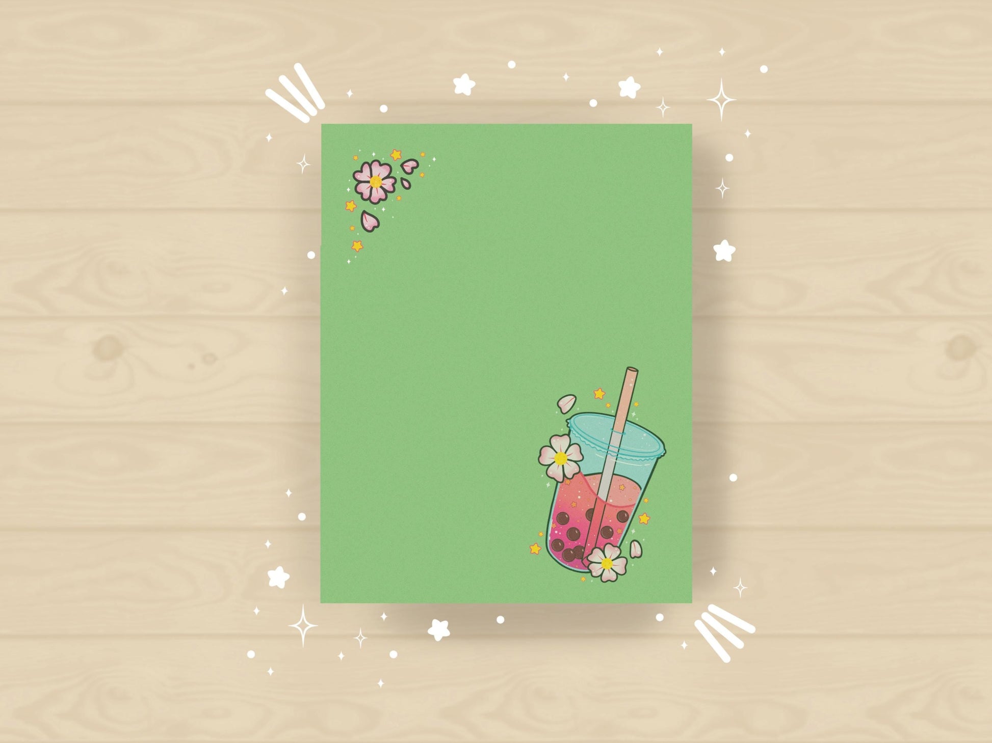 Green notepad with a pink boba milk tea illustration surrounded by pink flowers and yellow stars.