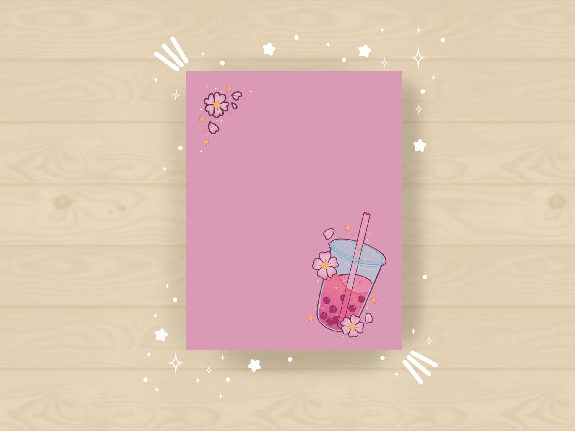 Pink notepad with a pink boba milk tea illustration surrounded by pink flowers and yellow stars.
