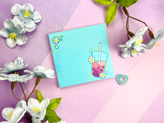 Light blue sticky notes with an illustration of pink boba milk tea surrounded by pink flowers.
