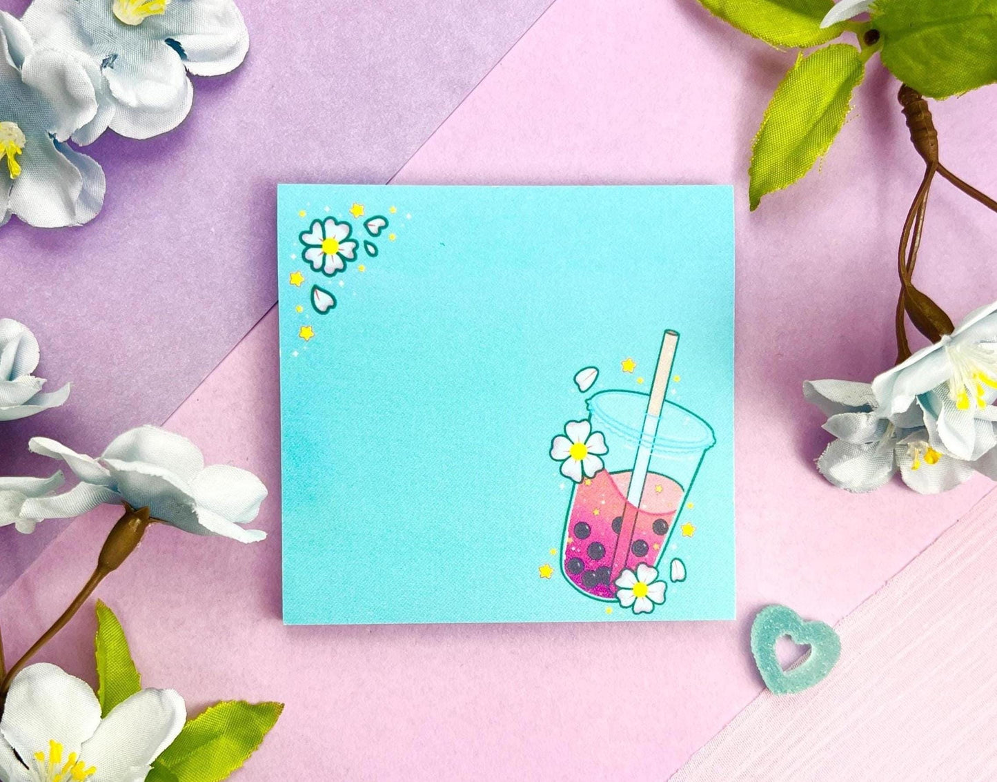 Light blue sticky notes with an illustration of pink boba milk tea surrounded by pink flowers.