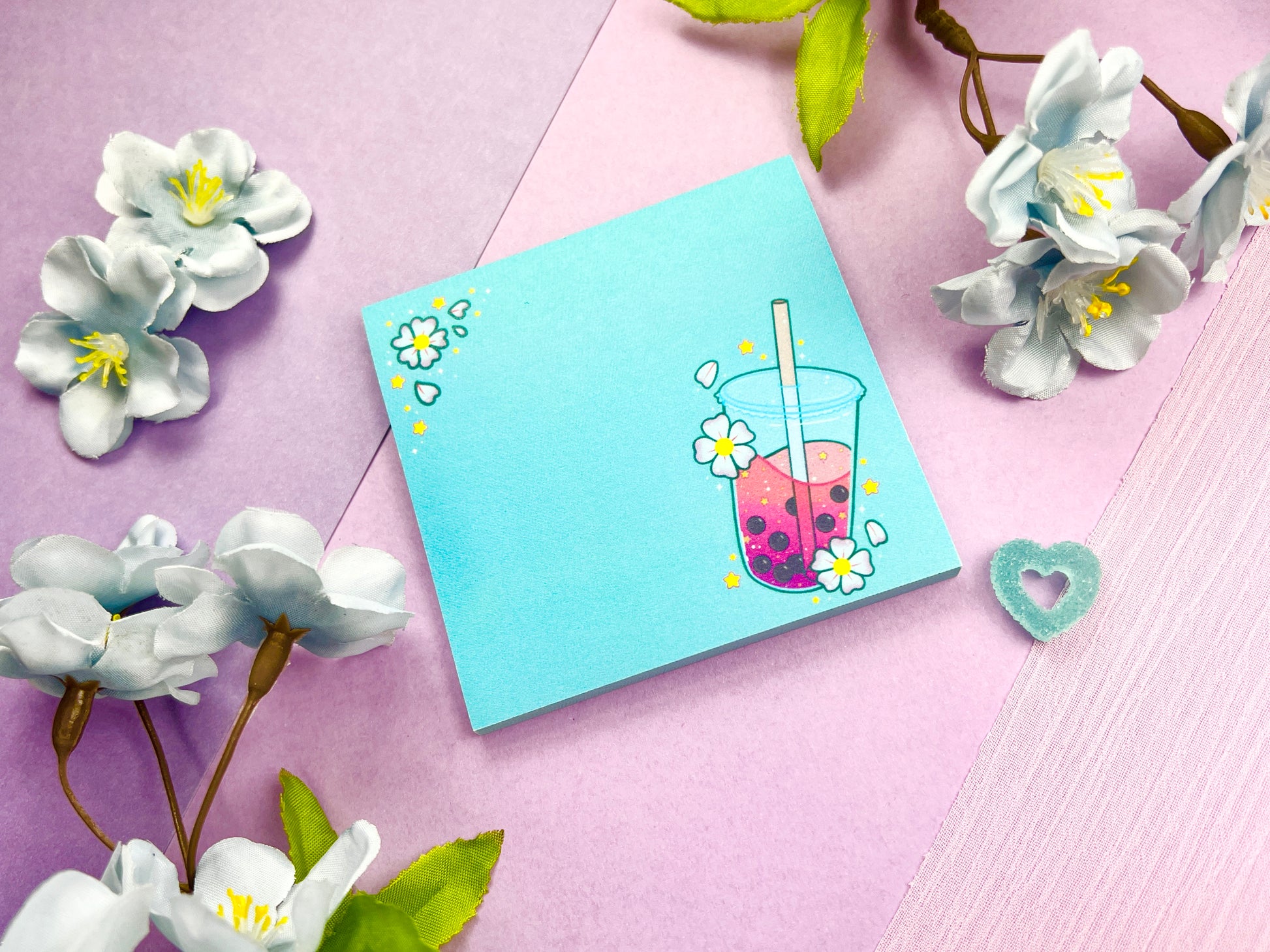 Light blue sticky notes with an illustration of pink boba milk tea surrounded by pink flowers.