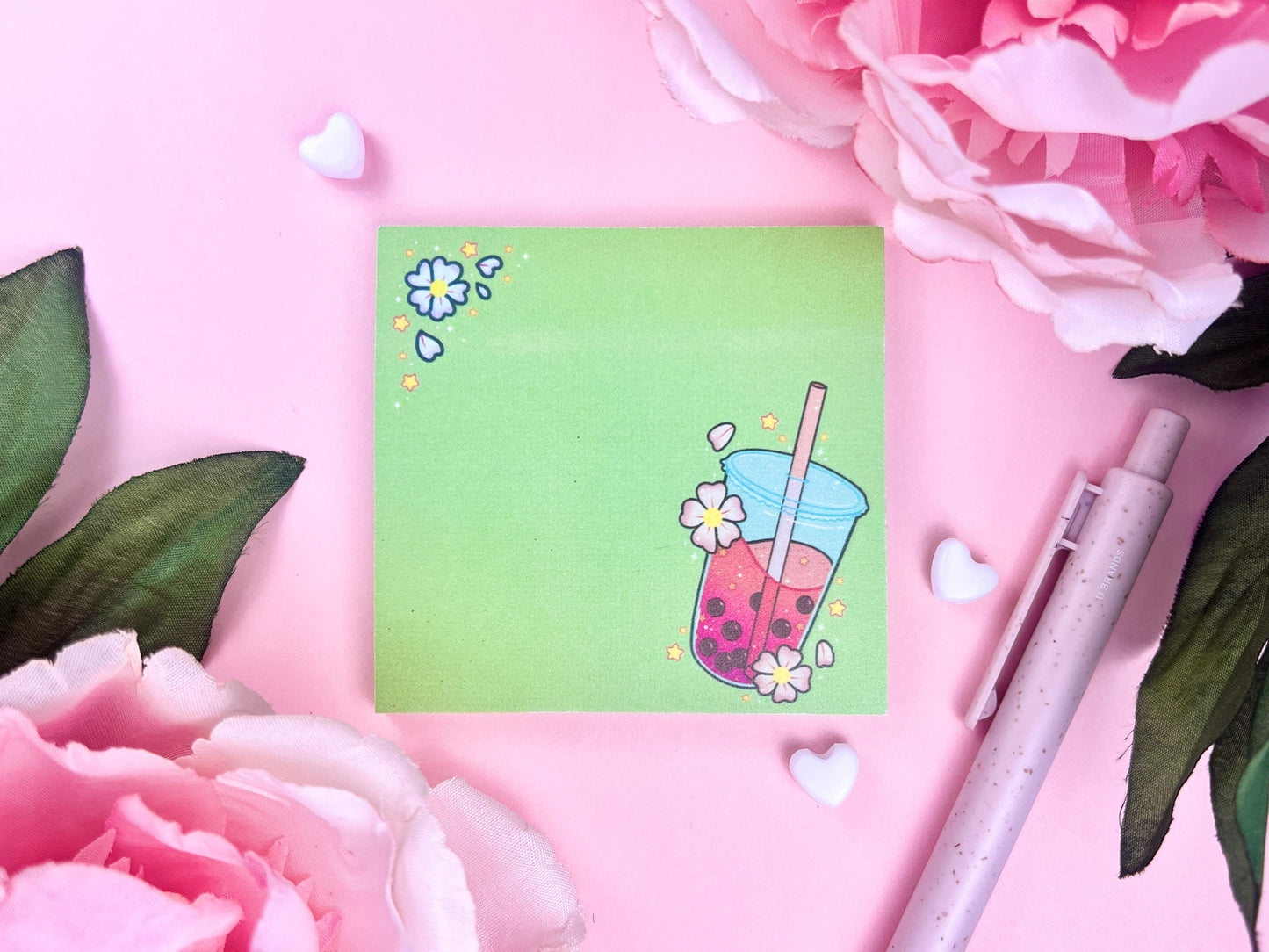 Light green sticky note with an illustration of pink boba milk tea surrounded by pink flowers and yellow stars.