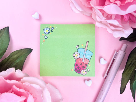 Light green sticky note with an illustration of pink boba milk tea surrounded by pink flowers and yellow stars.