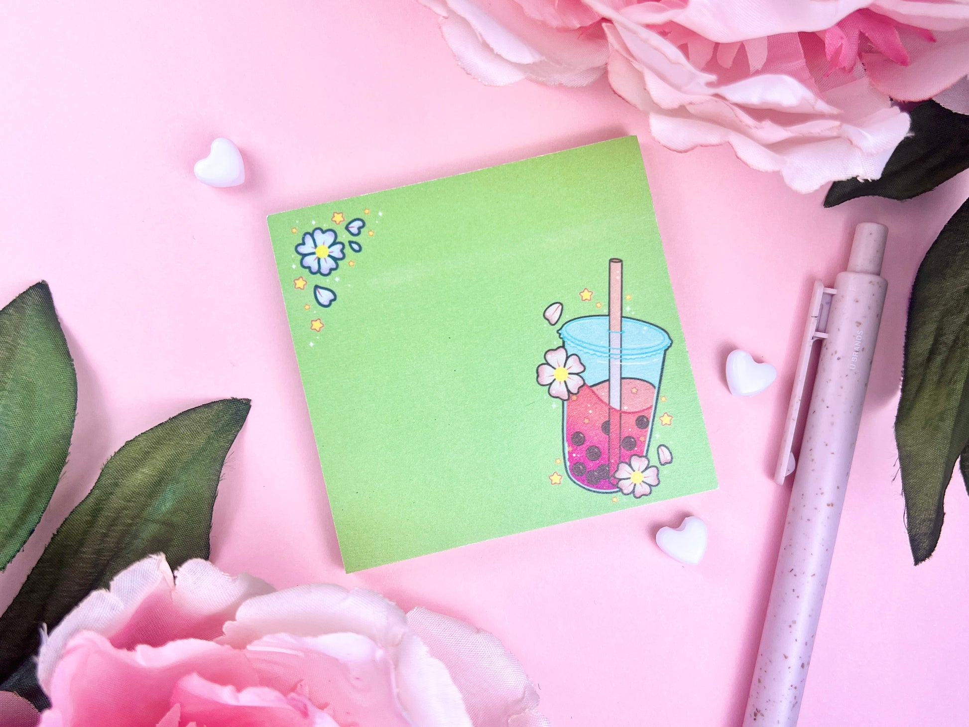 Light green sticky note with an illustration of pink boba milk tea surrounded by pink flowers and yellow stars.