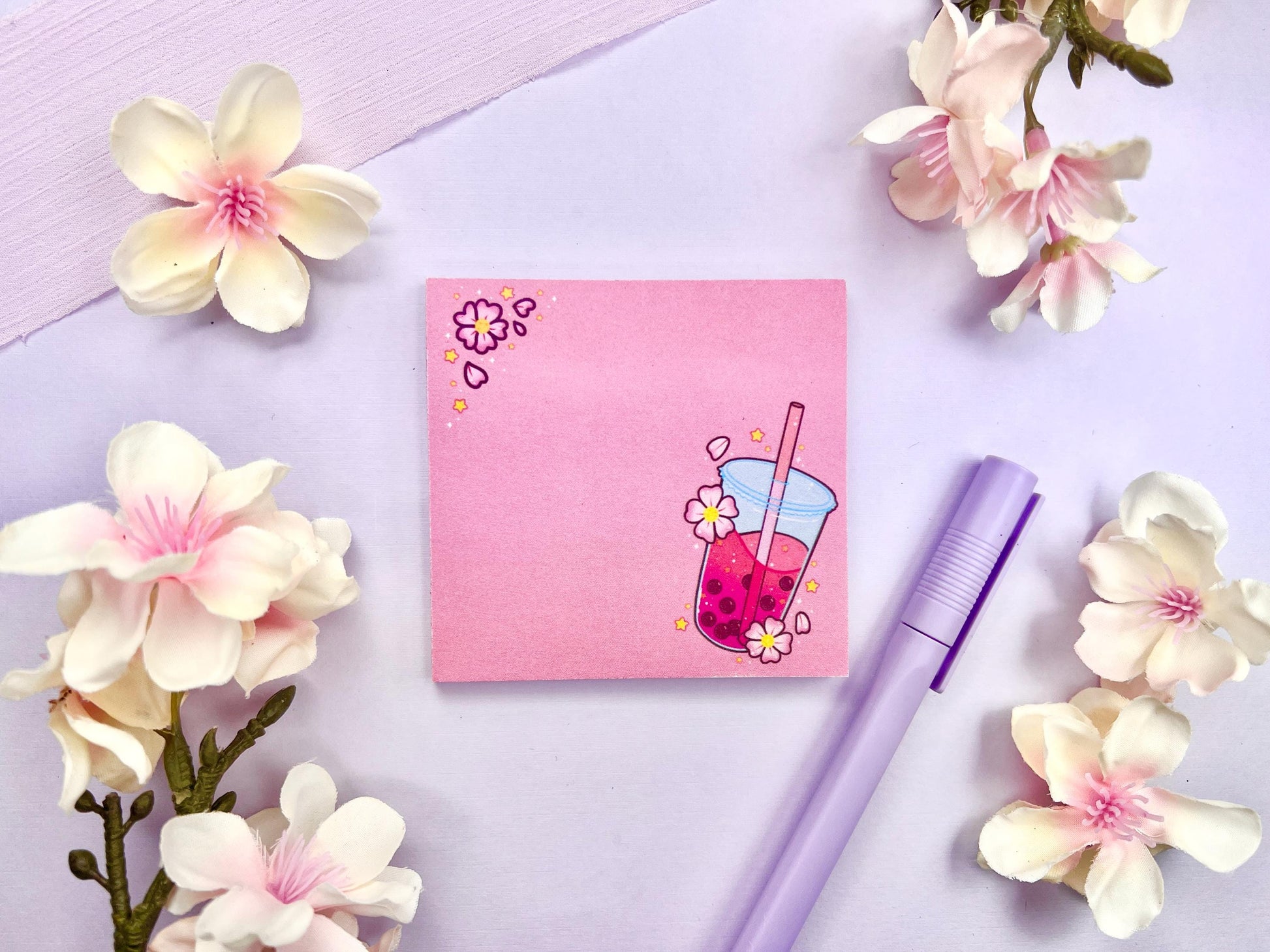 Pink sticky note with and illustration of pink boba milk tea surrounded by pink flowers and yellow stars.