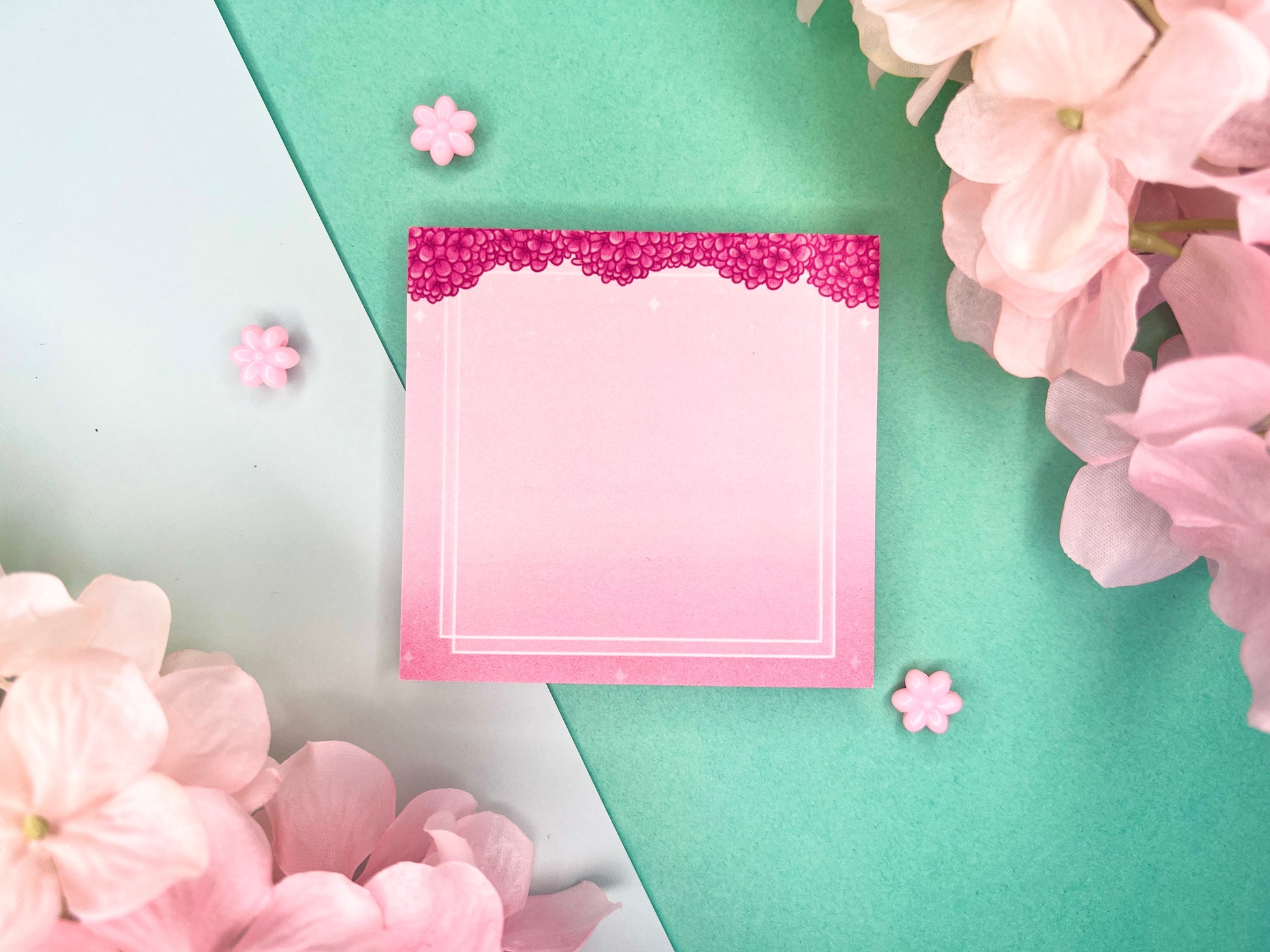 Pink sticky notes with a border of pink hydrangeas at the top and white squares around the rest.