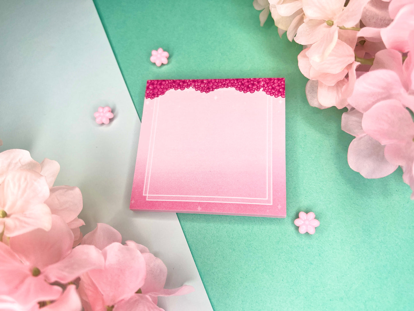 Pink sticky notes with a border of pink hydrangeas at the top and white squares around the rest.