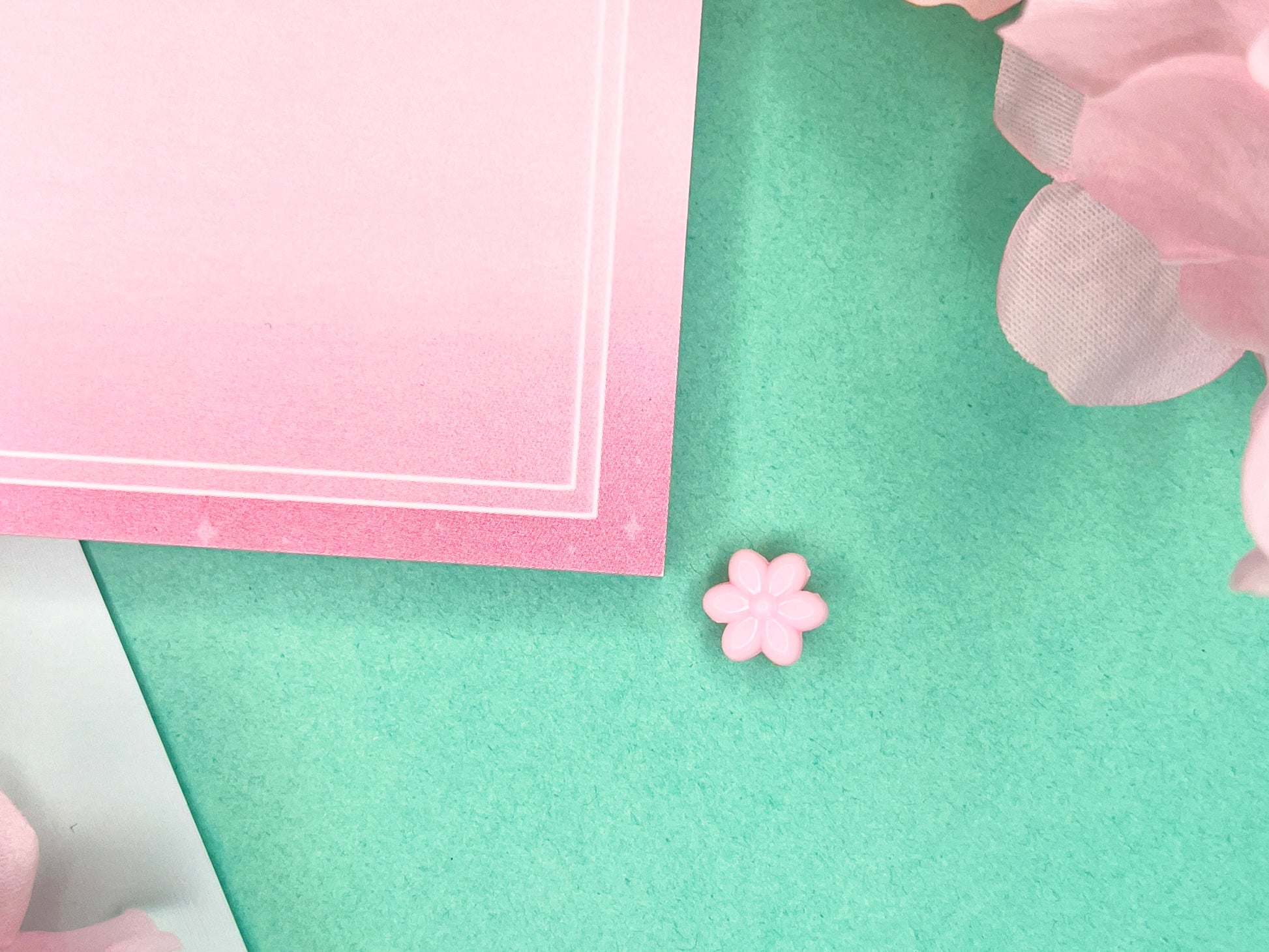 Pink sticky notes with a border of pink hydrangeas at the top and white squares around the rest.
