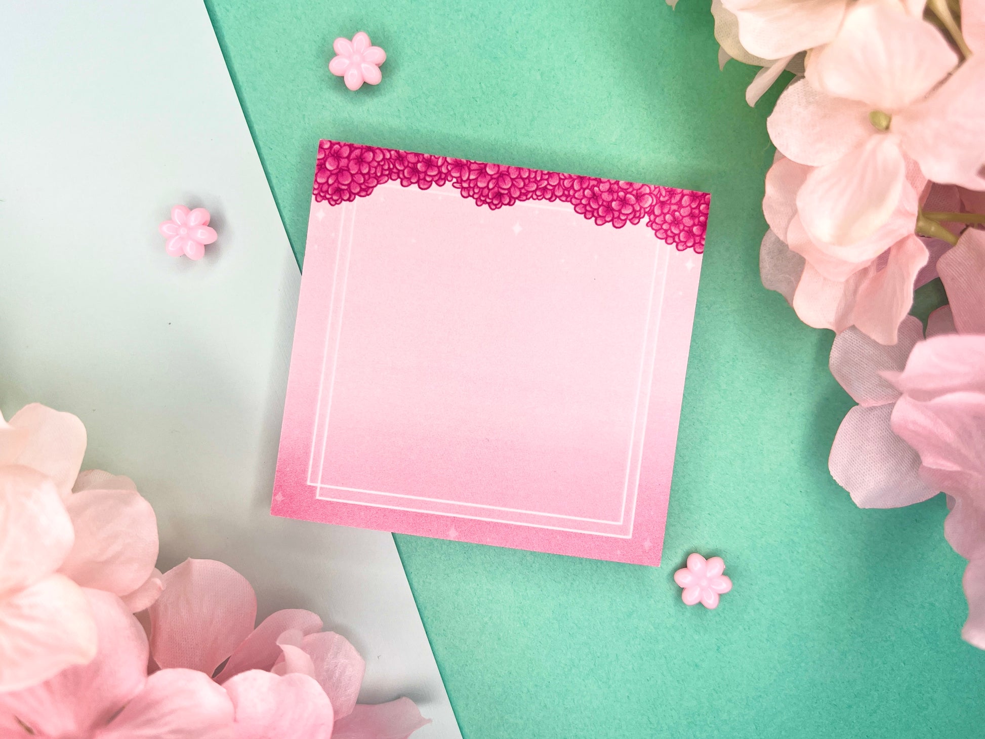 Pink sticky notes with a border of pink hydrangeas at the top and white squares around the rest.