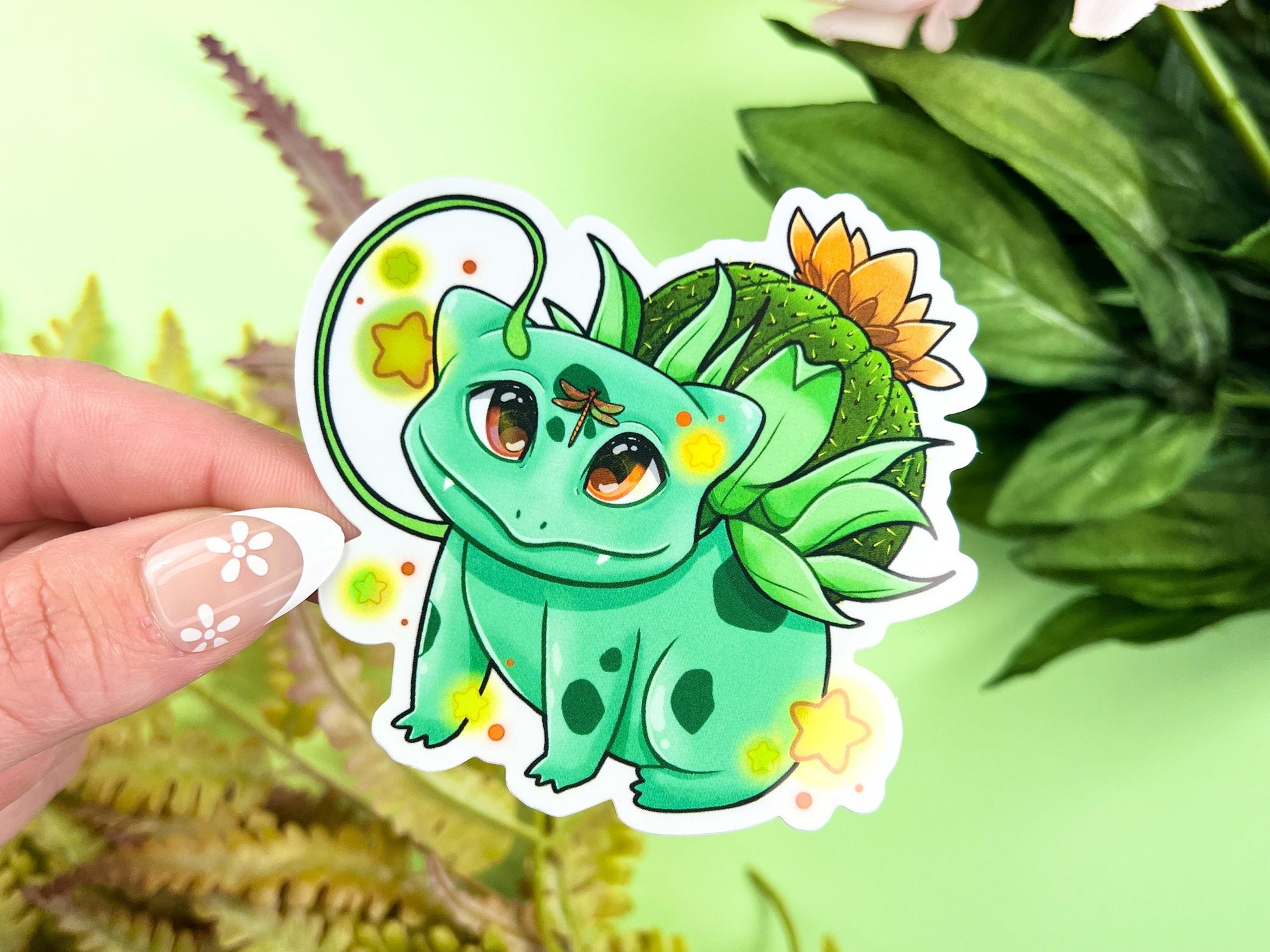 Vinyl sticker of a green leafy plant creature with cozy cottagecore forest aesthetic