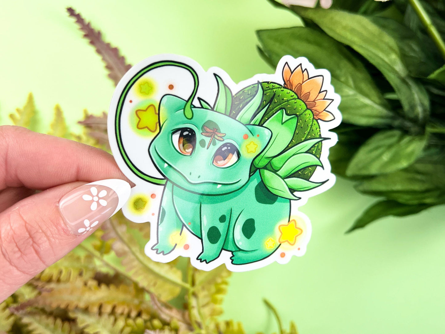 Vinyl sticker of a green leafy plant creature with cozy cottagecore forest aesthetic