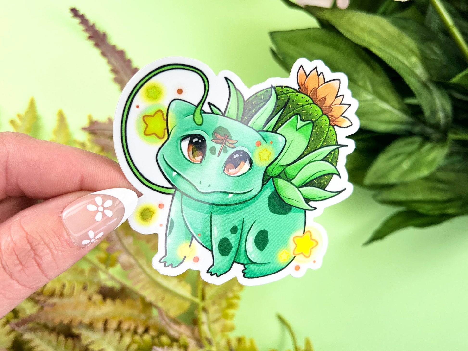 Vinyl sticker of a green leafy plant creature with cozy cottagecore forest aesthetic