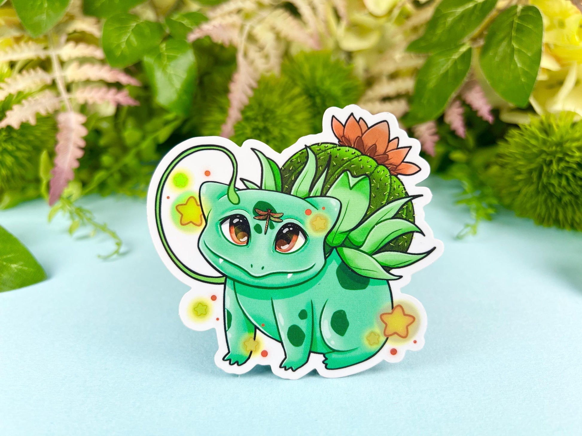 Vinyl sticker of a green leafy plant creature with cozy cottagecore forest aesthetic