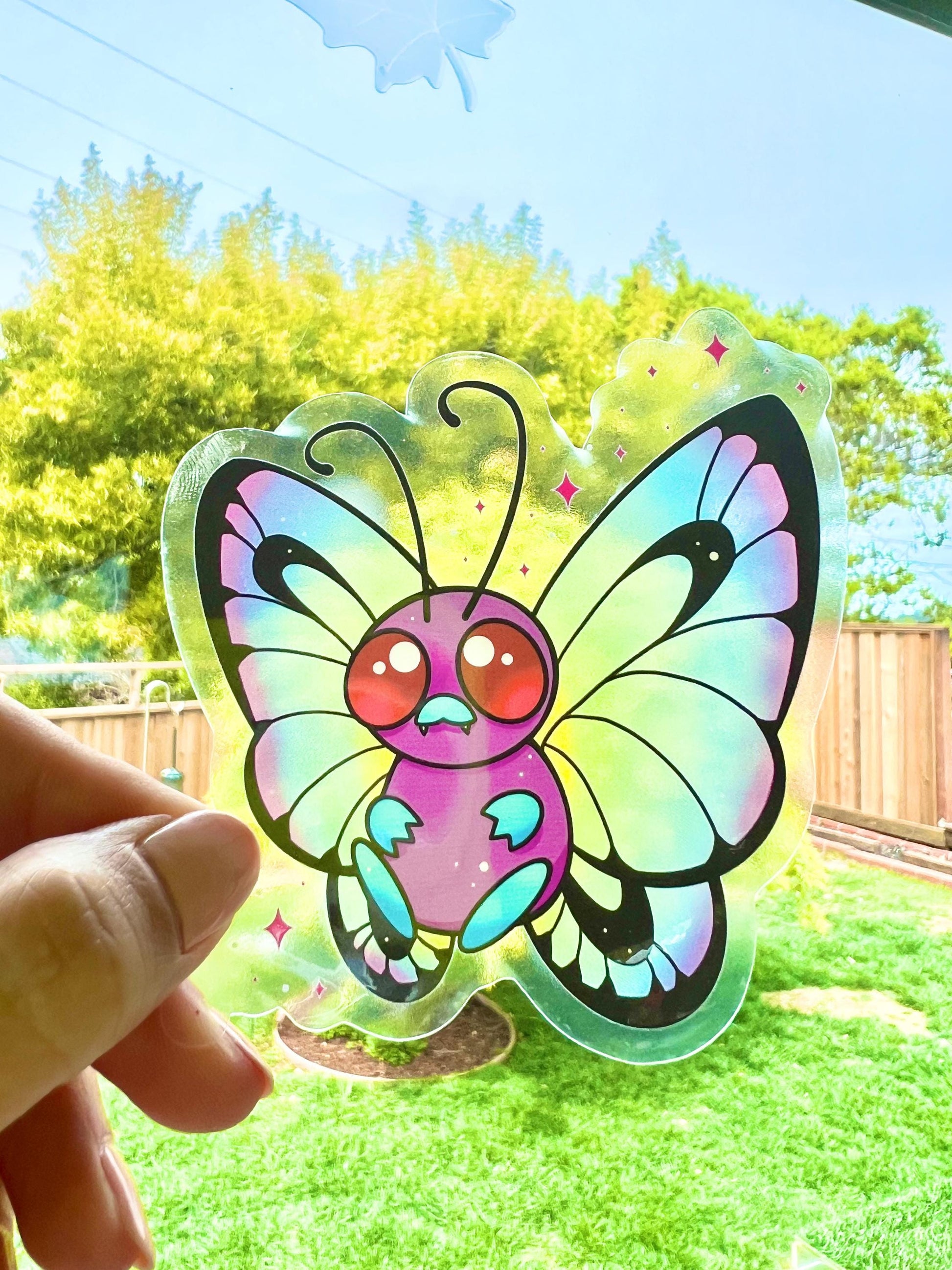 Cute colorful rainbow butterfly on a clear background sticker.
