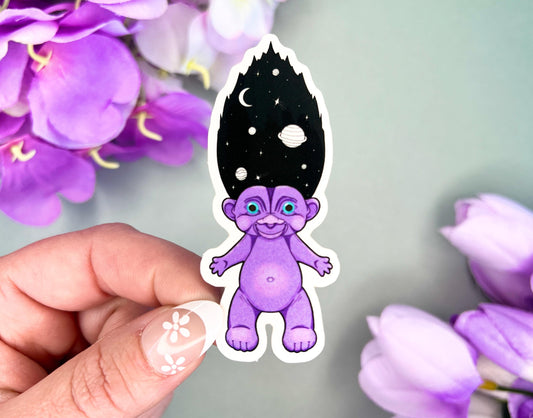 Retro Hair Creature sticker floating in a starry galaxy with neon colors, measuring about 3 inches tall.