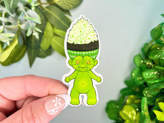 A green retro hair creature with green and brown hair made to look like a cupcake.