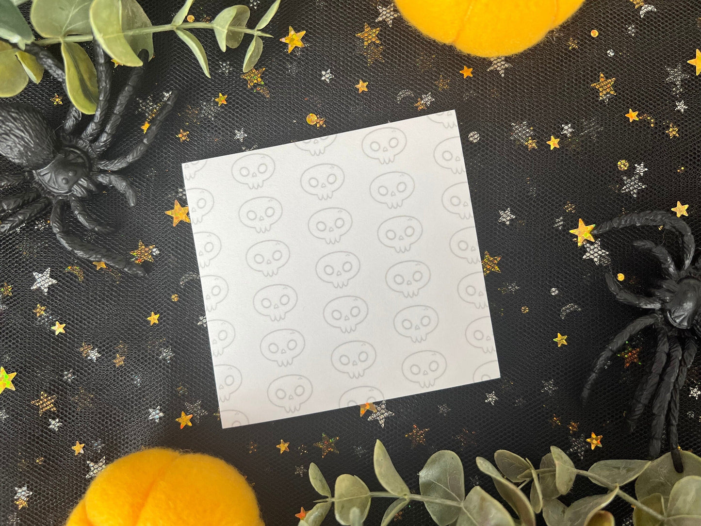 White sticky notes with a skull pattern along the entire background.