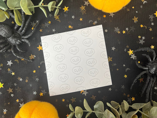 White sticky notes with a skull pattern along the entire background.