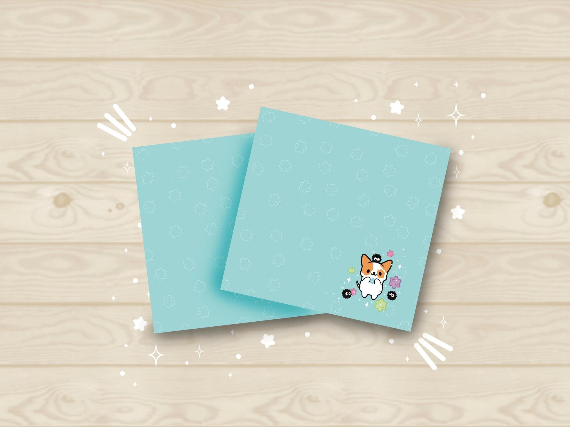 Blue sticky notes with an illustration of a cute dog playing with soot sprites and rainbow konpieto and has a konpieto patterned background.