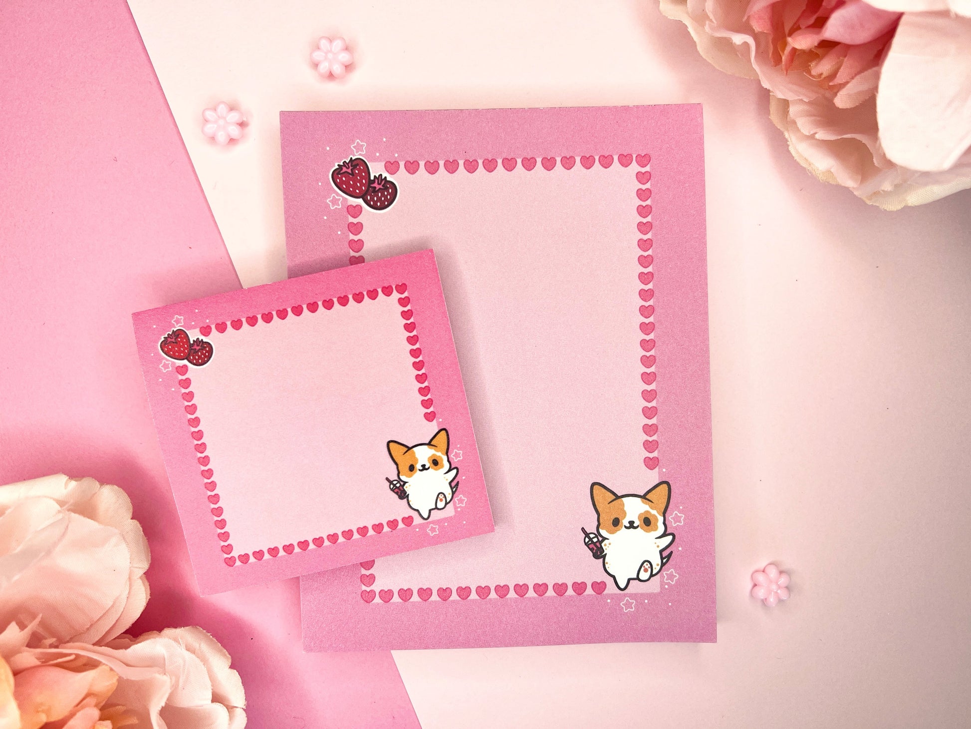 Pink gift set including one sticky note pad and one notepad with an illustration of a cute dog holding boba milk tea surrounded by hearts and strawberries.