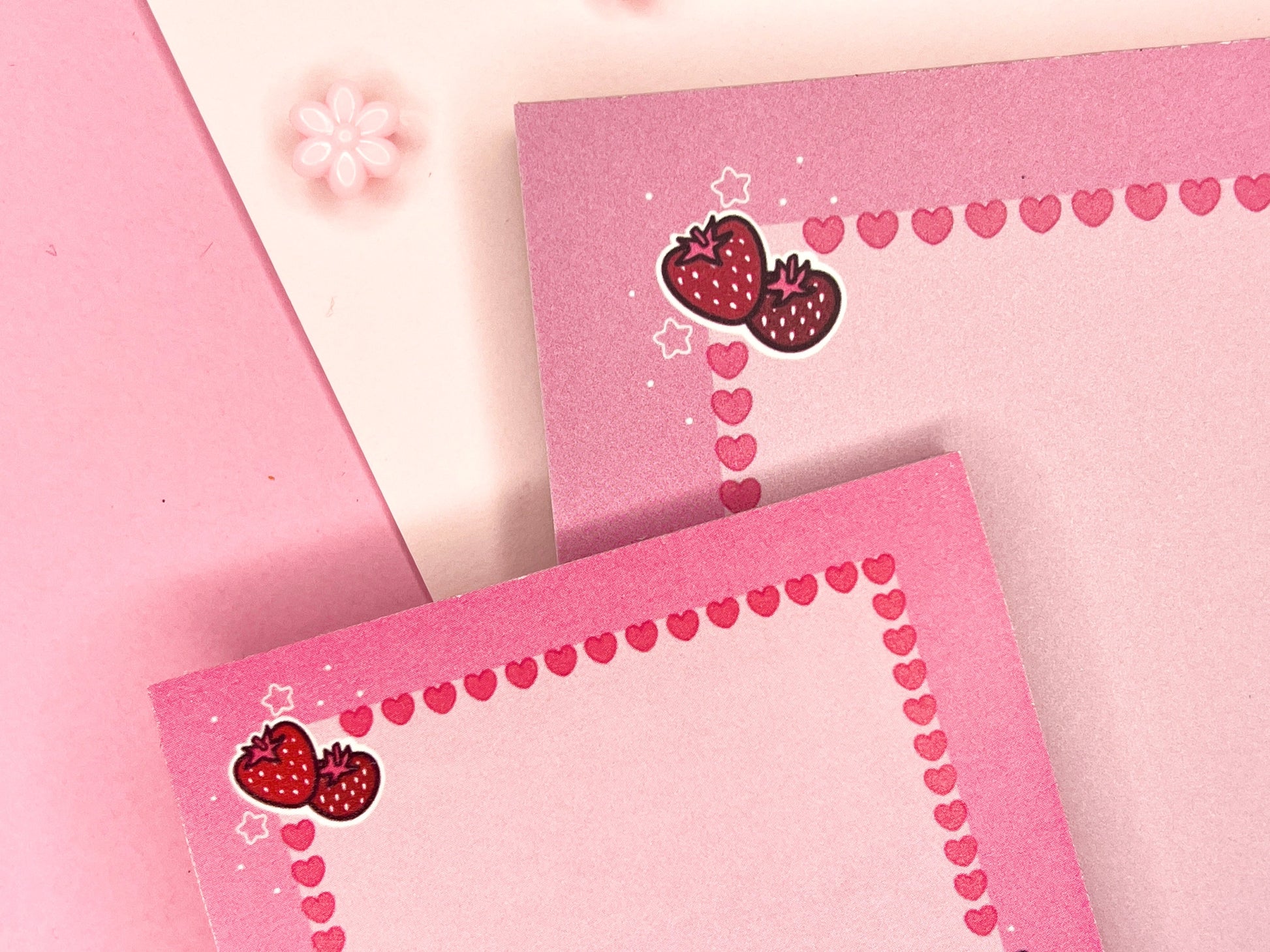 Pink gift set including one sticky note pad and one notepad with an illustration of a cute dog holding boba milk tea surrounded by hearts and strawberries.